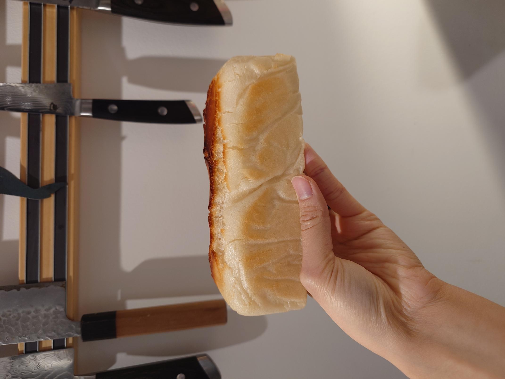 the side of a loaf of rice bread, where you can see the folds from the parchment paper