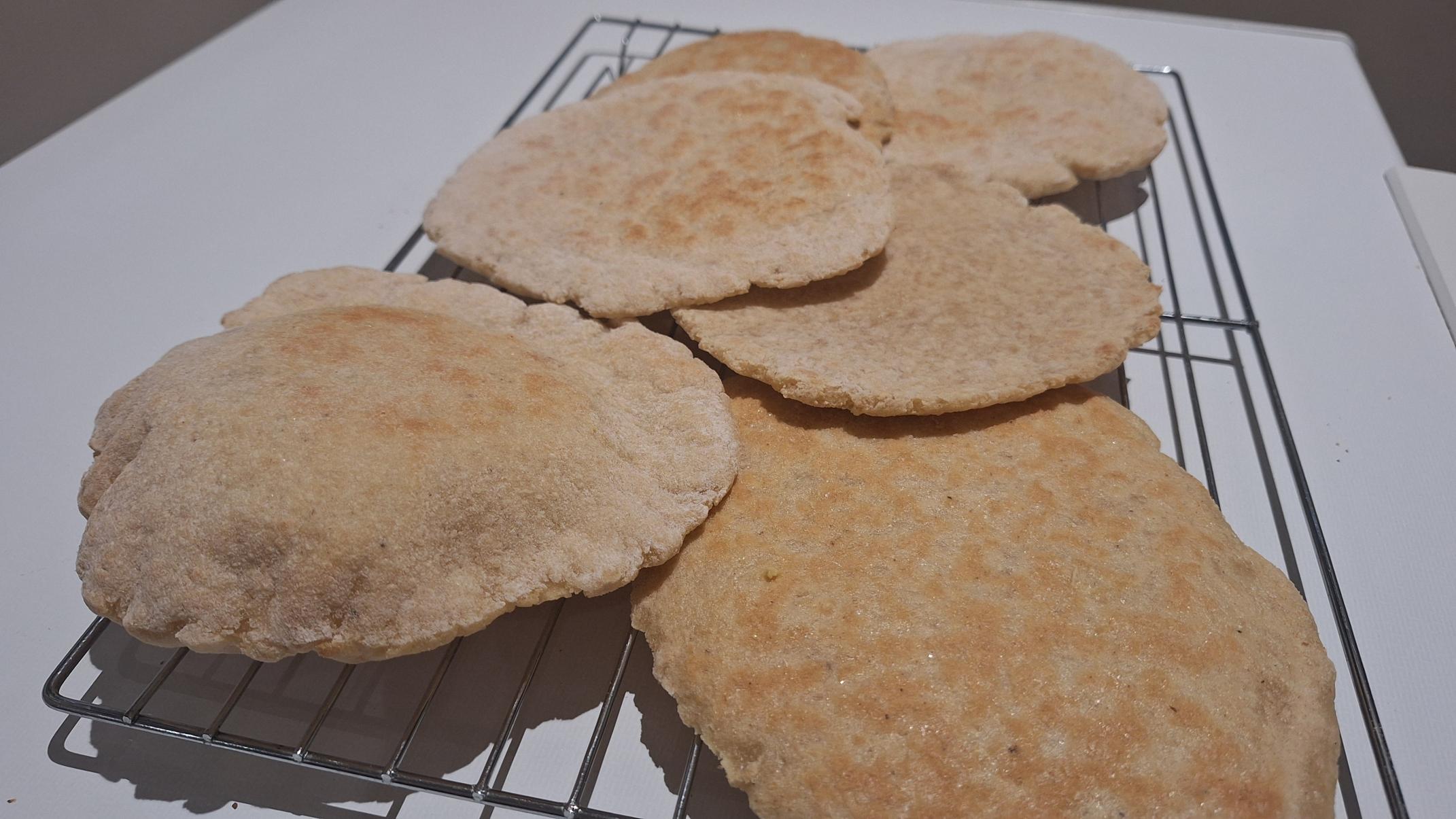 Photo of pita breads on coming rack 