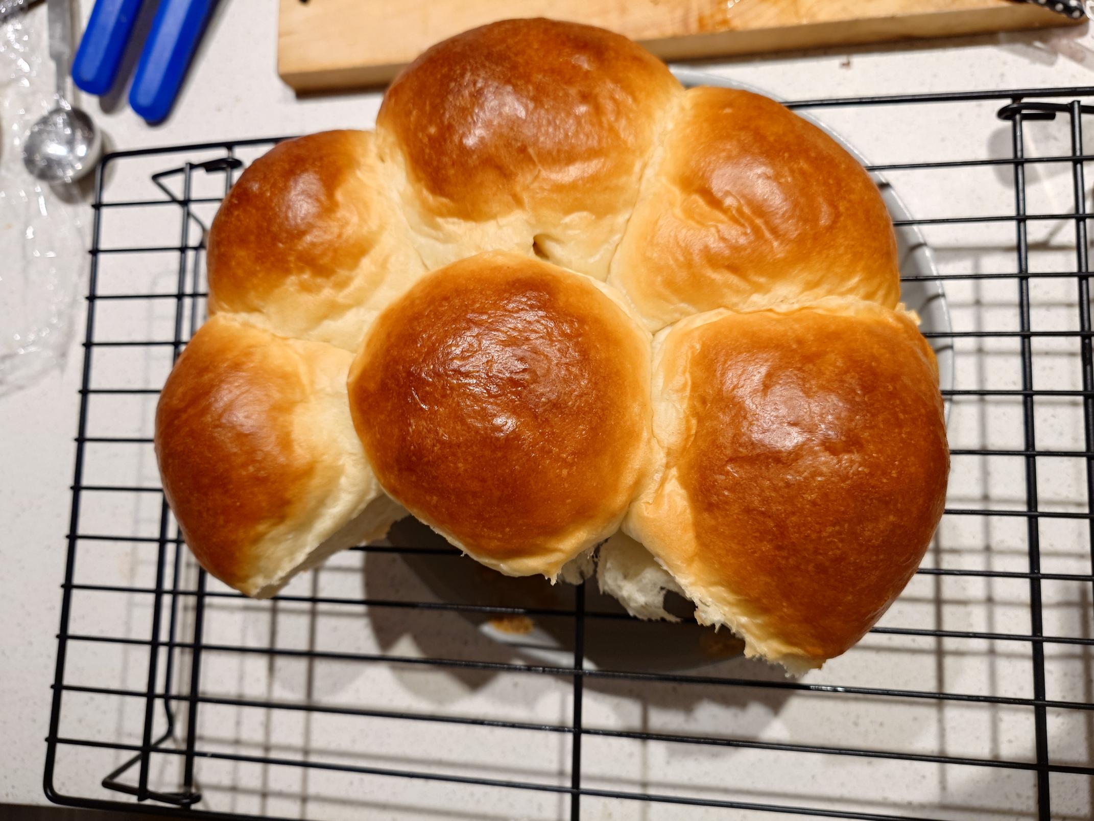 Milk bread rolls on a cooling rack