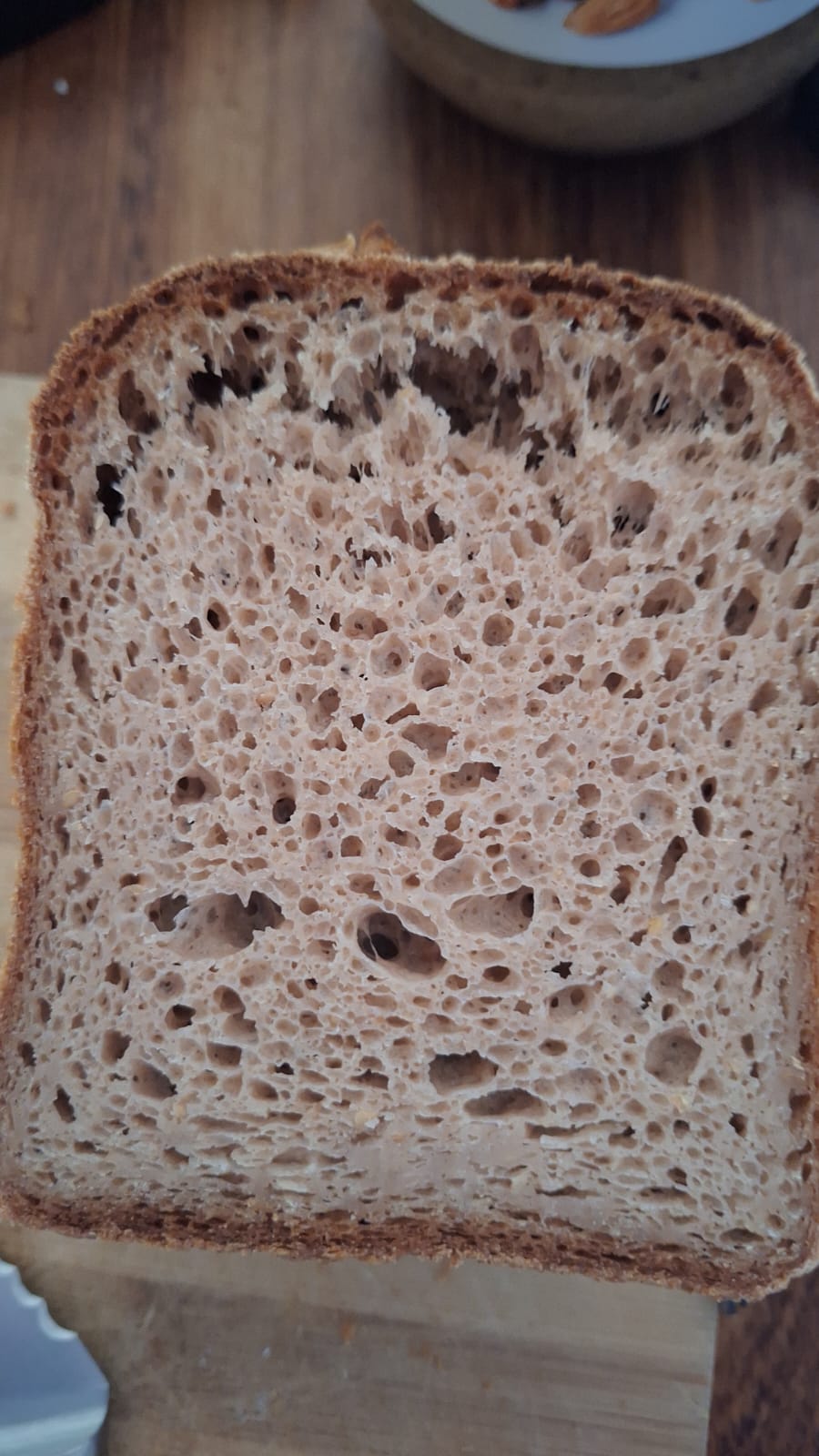 Slice of gluten free bread with the beginnings of a flying crust