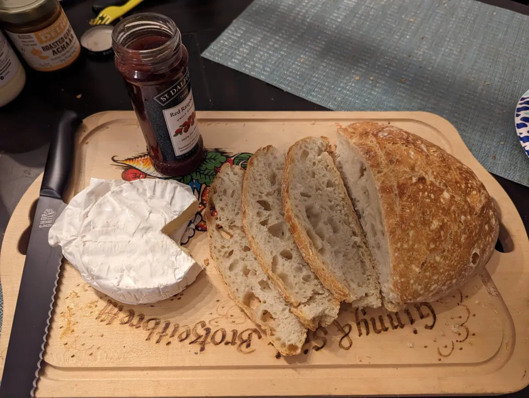 Loaf of bread on board with cheese